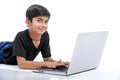 Cute little Indian/Asian boy studying or playing game with laptop computer Royalty Free Stock Photo