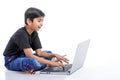 Cute little Indian/Asian boy studying or playing game with laptop computer Royalty Free Stock Photo