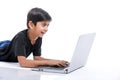 Cute little Indian/Asian boy studying or playing game with laptop computer Royalty Free Stock Photo