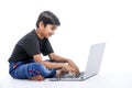 Cute little Indian/Asian boy studying or playing game with laptop computer Royalty Free Stock Photo