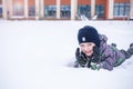 Cute little kid boy in colorful winter clothes laying down on . Active outdoors leisure with children in . Happy child. Royalty Free Stock Photo