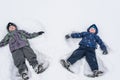 Cute little kid boy in colorful winter clothes laying down on . Active outdoors leisure with children in . Happy child. Royalty Free Stock Photo