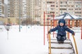 Cute little kid boy in colorful winter clothes laying down on . Active outdoors leisure with children in . Happy child. Royalty Free Stock Photo