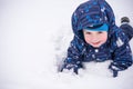 Cute little kid boy in colorful winter clothes making snow angel Royalty Free Stock Photo