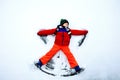 Cute little kid boy in colorful winter clothes making snow angel, laying down on snow. Active outdoors leisure with Royalty Free Stock Photo