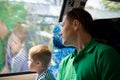 Cute little kid boy looking at the city out of the train window while traveling with his father.  Child travelling by railway. Royalty Free Stock Photo