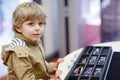 Cute little kid boy at optician store during choosing his new glasses Royalty Free Stock Photo