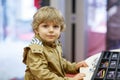 Cute little kid boy at optician store during choosing his new glasses Royalty Free Stock Photo