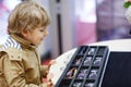 Cute little kid boy at optician store during choosing his new glasses Royalty Free Stock Photo