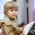 Cute little kid boy at optician store during choosing his new gl Royalty Free Stock Photo