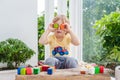 Cute little kid boy with playing with lots of colorful plastic blocks indoor. Active child having fun with building and Royalty Free Stock Photo