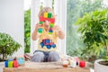 Cute little kid boy with playing with lots of colorful plastic blocks indoor. Active child having fun with building and creating o Royalty Free Stock Photo