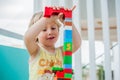 Cute little kid boy playing with lots of colorful plastic blocks indoor. Active child having fun with building and creating of tow Royalty Free Stock Photo