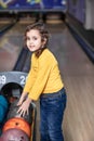 Cute little kid girl with ball at bowling club Royalty Free Stock Photo