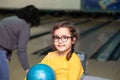 Cute little kid girl with ball at bowling club Royalty Free Stock Photo