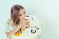 Cute little kid girl kissing hugging her white bear toy in studio Royalty Free Stock Photo