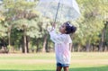 Cute little kid girl playing outdoors in the garden, Child girl with umbrella in the park Royalty Free Stock Photo
