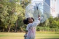 Cute little kid girl playing outdoors in the garden, Child girl with umbrella playing rain in the park Royalty Free Stock Photo