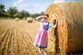 Cute little kid girl in traditional Bavarian costume in wheat field Royalty Free Stock Photo