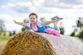 Cute little kid girl in traditional Bavarian costume in wheat field Royalty Free Stock Photo