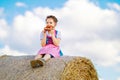 Cute little kid girl in traditional Bavarian costume in wheat field Royalty Free Stock Photo