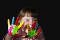 Cute little kid with painted hands isolated on the black Royalty Free Stock Photo