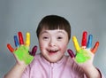 Cute little kid with painted hands. Isolated on grey background Royalty Free Stock Photo