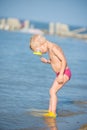 Cute little kid wearing mask and flippers for diving at sand tropical beach. Royalty Free Stock Photo