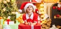 Cute little kids celebrating Christmas. Christmas kids celebration holiday. Happy cute child in Santa hat with present Royalty Free Stock Photo