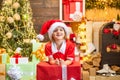 Cute little kids celebrating Christmas. Christmas Celebration holiday. Happy cute child in Santa hat with present have a Royalty Free Stock Photo