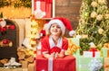 Cute little kids celebrating Christmas. Christmas Celebration holiday. Happy cute child in Santa hat with present have a Royalty Free Stock Photo