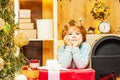 Cute little kids celebrating Christmas. Portrait of Santa kid with huge red gift looking at camera. Happy new year Royalty Free Stock Photo