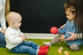 Cute little kids in nursery play with balls and smile