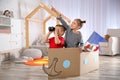 Cute little kids playing with binoculars and cardboard boat Royalty Free Stock Photo