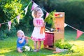 Cute little kids playing with toy kitchen in the garden Royalty Free Stock Photo