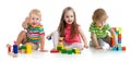 Cute little kids playing with toys or blocks and having fun while sitting on floor isolated over white background Royalty Free Stock Photo