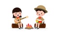 Cute little kids sitting on a log and playing guitar and bongo drums by campfire, boy scout or girl scout honor uniform