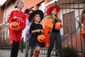 Cute little kids wearing Halloween costumes going trick-or-treating Royalty Free Stock Photo