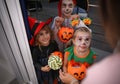 Cute little kids wearing Halloween costumes and trick-or-treating Royalty Free Stock Photo