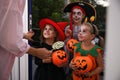 Cute little kids wearing Halloween costumes and trick-or-treating Royalty Free Stock Photo