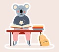 Cute little Koala bear student working at a desk
