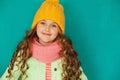 Cute little lady wearing yellow woolen cap and warm scarf