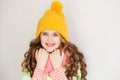 Cute little lady wearing yellow woolen cap and warm scarf