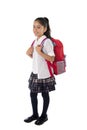 Cute little latin school girl carrying schoolbag backpack and books smiling