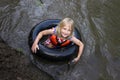 Cute Little Muddy Girl Child Swimming in Tube in River Royalty Free Stock Photo