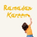 Cute little Muslim girl drawing Ramadan Kareem