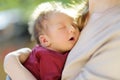 Cute little newborn baby boy in his mothers arms. Portrait of tiny new baby at home. Adorable son being held by his mommy Royalty Free Stock Photo