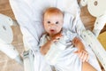 Cute little newborn girl drinking milk from bottle and looking at camera on white background. Infant baby sucking eating Royalty Free Stock Photo