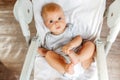 Cute little newborn girl with smiling face looking at camera on white background. Infant baby resting playing lying down Royalty Free Stock Photo