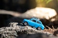 Cute little nonexistent retro car travelling in a woodlands Royalty Free Stock Photo